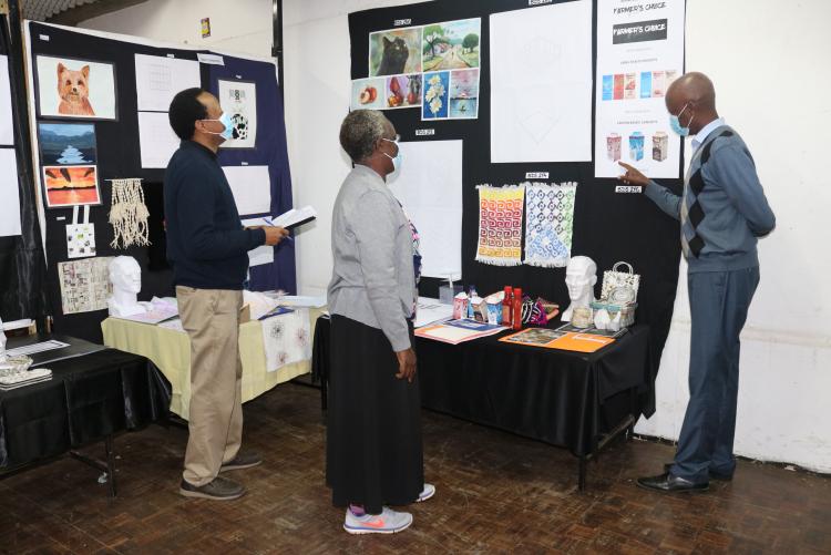 The Director StAD, Dr Lilac Osanjo, Dr. Mbathi from Dept Urban Planning and the Exams Coordinator Mr. Makunda assessing one of the pinned up portfolios