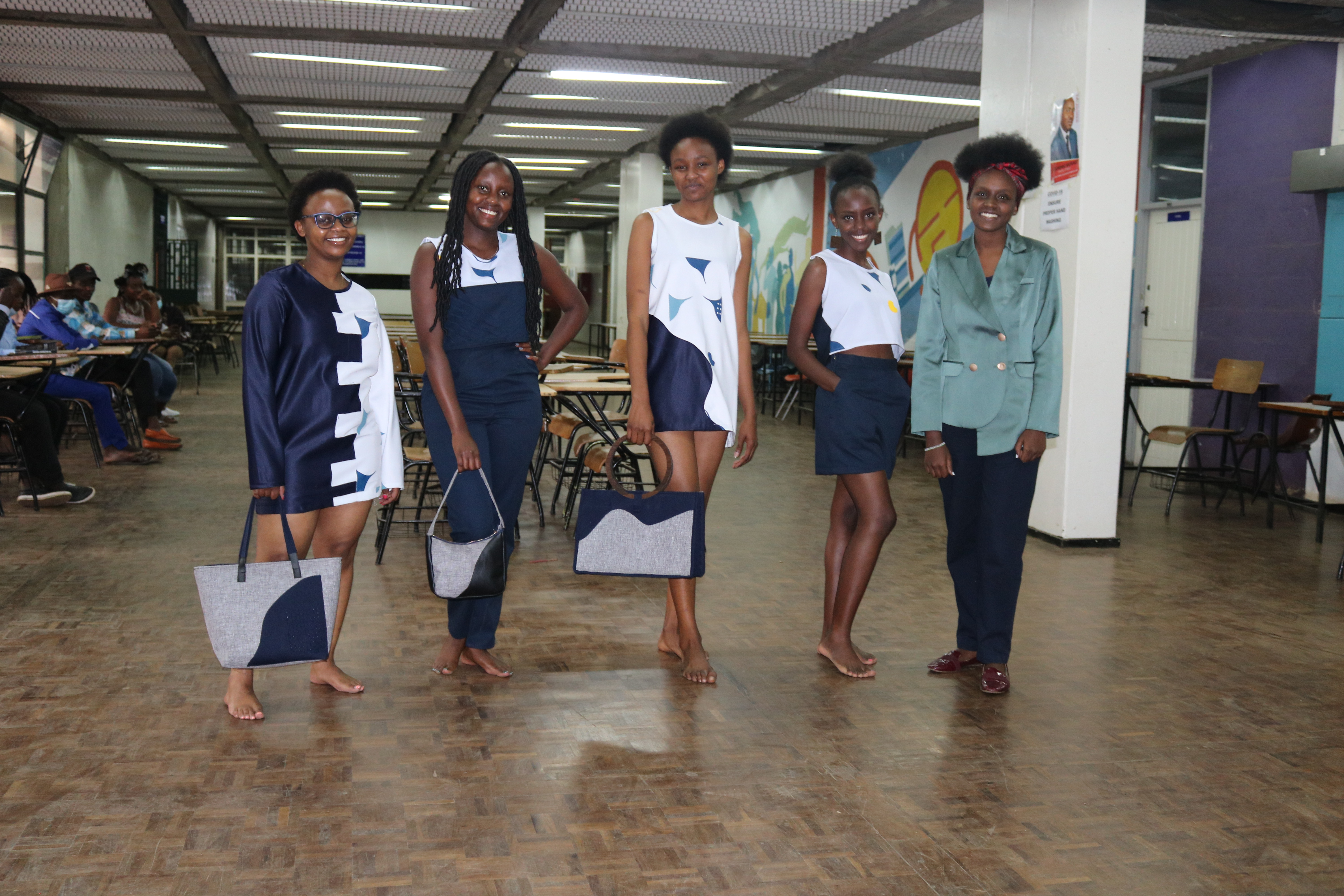 4th year fashion design student poses with models in her outfits