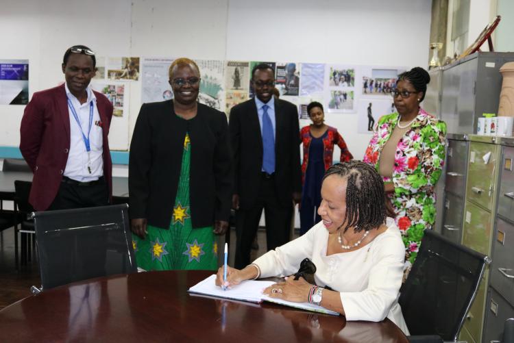 Prof Eudine Barriteau, Pro- Vice Chancellor of the University of West Indies signing the guests register at the Director's office.