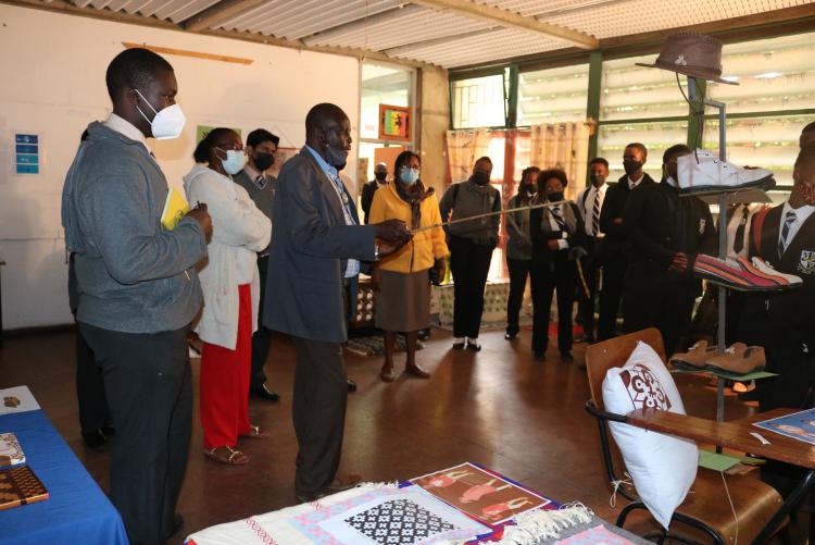 Mr. Ouma fro Stad makes a presentation of the Design exhibition to students  from St Mary's School Nairobi
