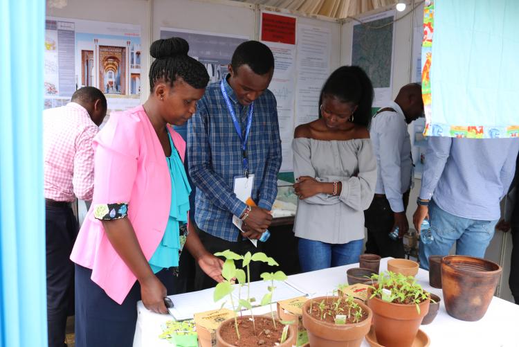 Salome Ngunu from the department of Arts and Design takes participants of the Innovation week through ceramic products on display at the Design stand. 